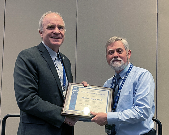 January 2026 JANNAF Meeting Chair, Robert Baurle, PhD, presented the APS Best Paper Award to Richard Gaffney, PhD, who accepted the award on behalf of Robin L. Hunt, PhD.